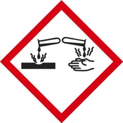 Op de verpakking van BM Beton Verwijderaar BIO wordt een pictogram gebruikt van chemische stoffen uit reageerbuisjes die een oppervlak en een hand aantasten, binnen een rode ruitvormige omranding, om aan te geven dat het product bijtend is.